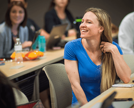 Student smiling during class discussion