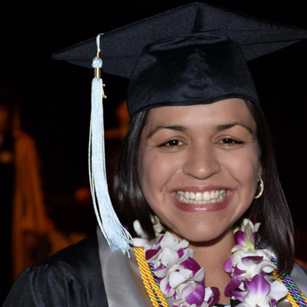 Photo of NSC graduate in cap and gown