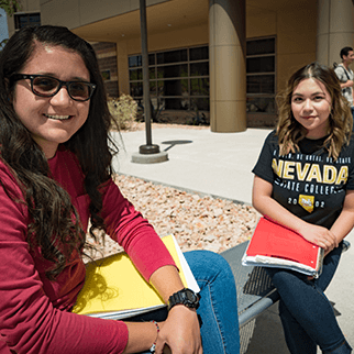 Two students sitting outside on campus