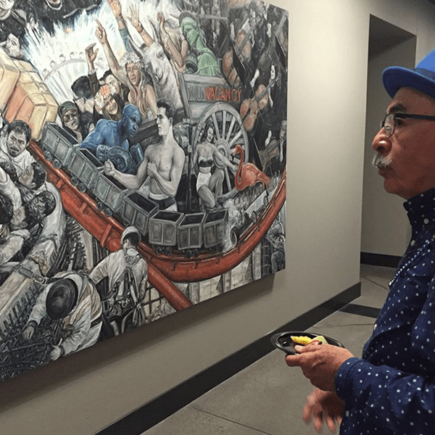 Former Poet Laureate admiring art on NSC campus