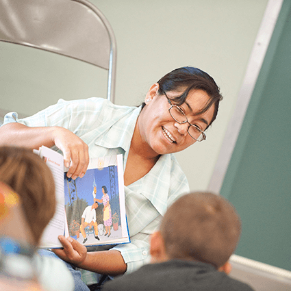 NSC Education student reading book to students