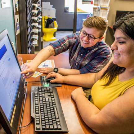 Picture of two students in the Career Services Center on the computer.