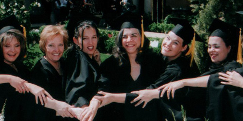 Close up of a group of women in their caps and gowns.