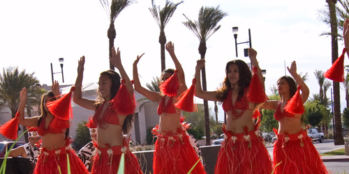 Women in red costumes doing dance together