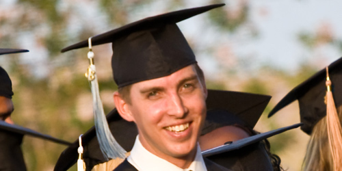 Male graduate with cap and gown on