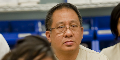 Male student with glasses looking into camera