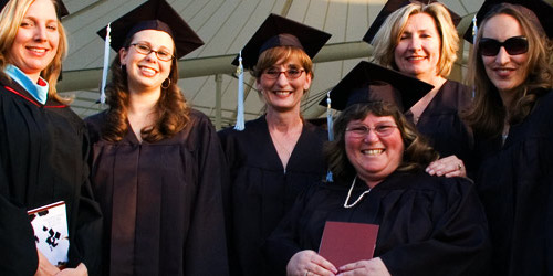 Picture of female graduating students smiling at camera