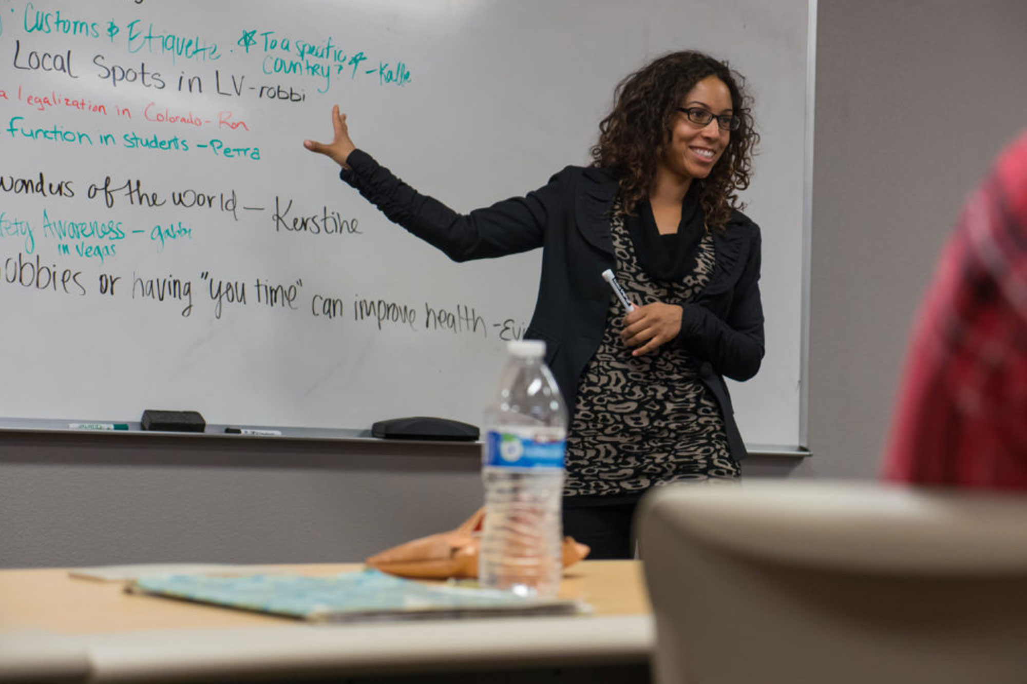 Communications Professor, Dr. Jasmine Phillips using whiteboard to teach