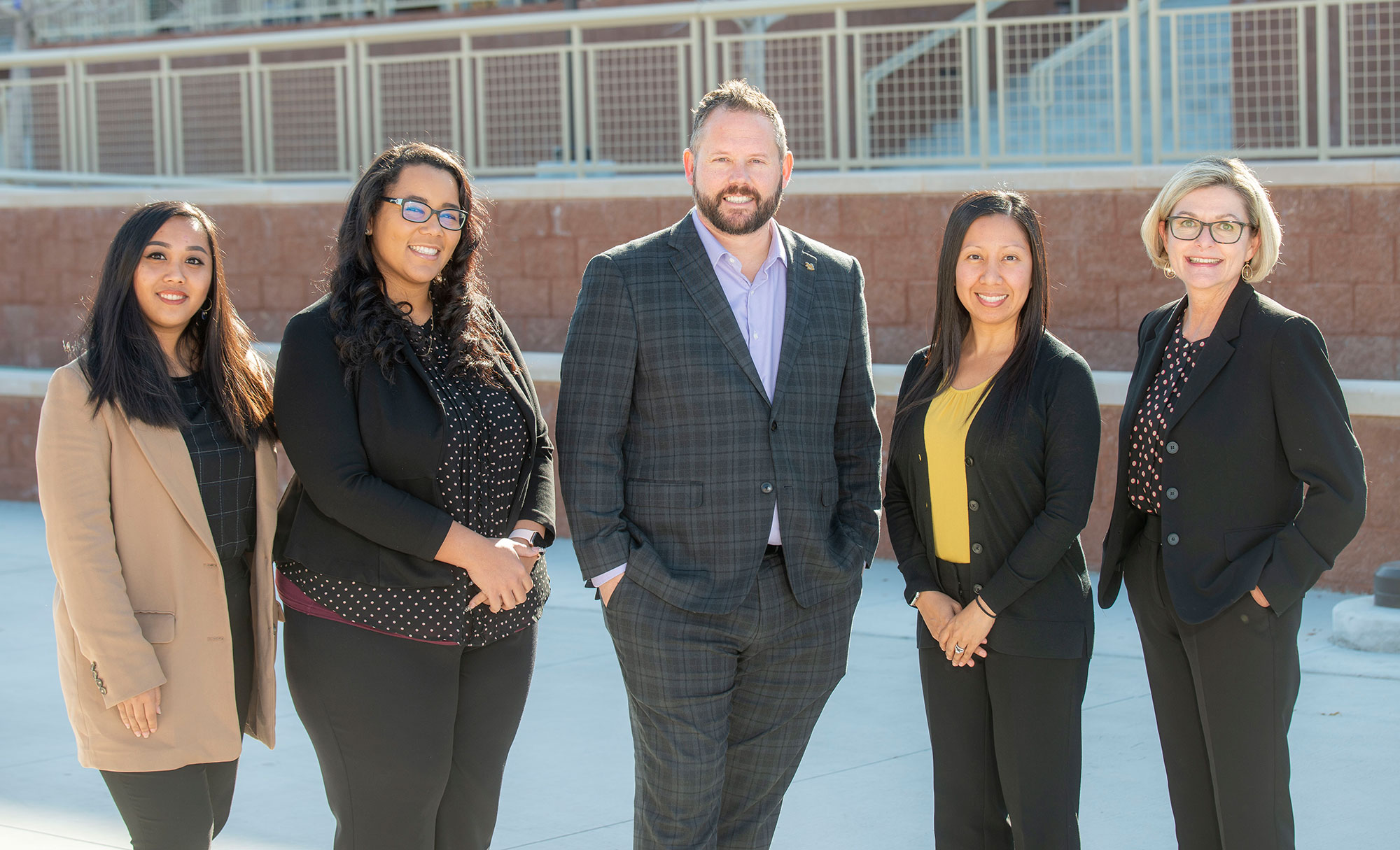 HR department of 5 people all posing together for photo