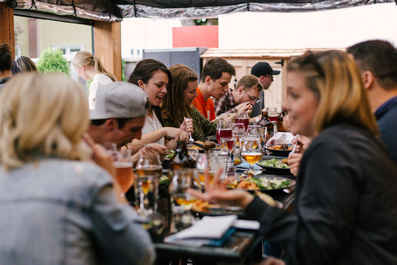 long table of people eating together